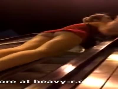 Girl In Mini Skirt Tries To Slide Down Escalator
